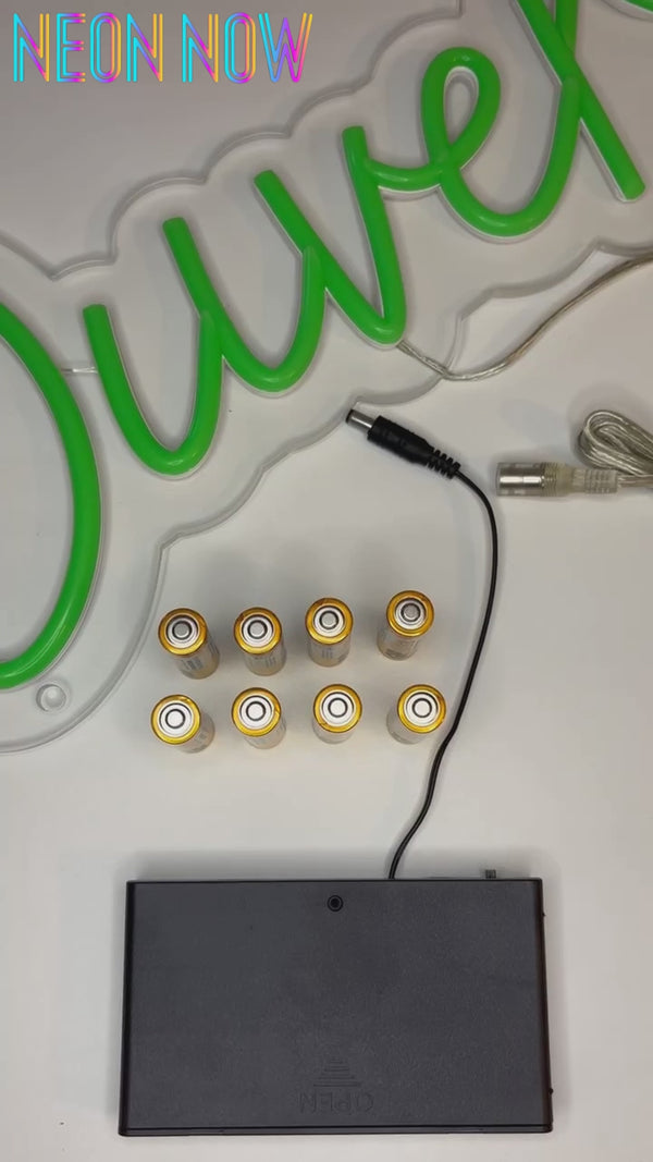 Battery-operated LED neon sign in use – cordless, energy-efficient lighting solution for homes, events, and retail displays. Powered without a wall socket.